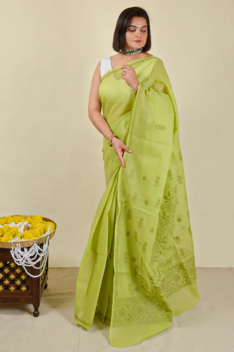 Handcrafted Green Cotton Saree with intricate Lucknowi Chikankari embroidery and a matching blouse, ideal for festive and wedding occasions.