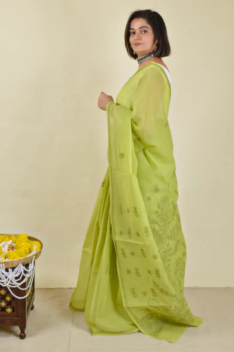 Handcrafted Green Cotton Saree with intricate Lucknowi Chikankari embroidery and a matching blouse, ideal for festive and wedding occasions.