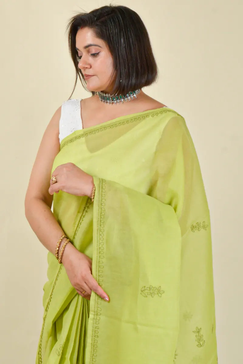 Handcrafted Green Cotton Saree with intricate Lucknowi Chikankari embroidery and a matching blouse, ideal for festive and wedding occasions.