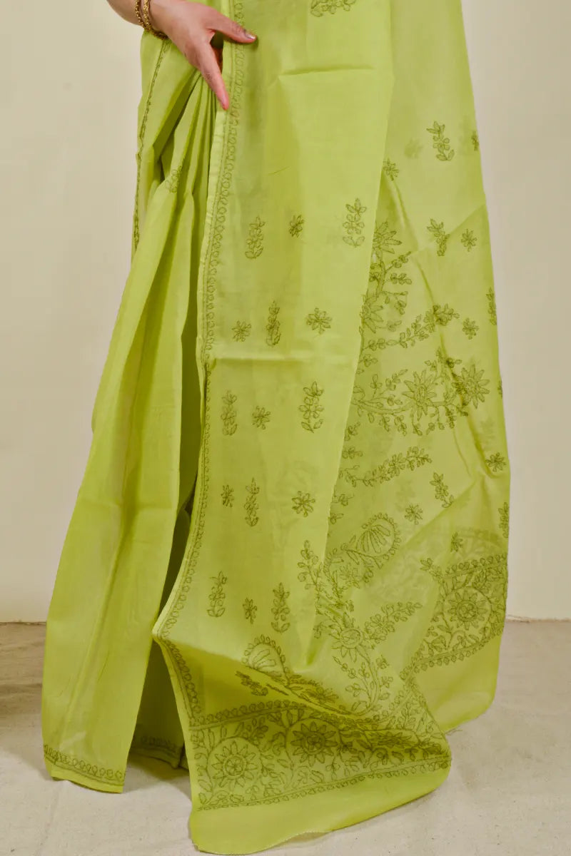 Handcrafted Green Cotton Saree with intricate Lucknowi Chikankari embroidery and a matching blouse, ideal for festive and wedding occasions.