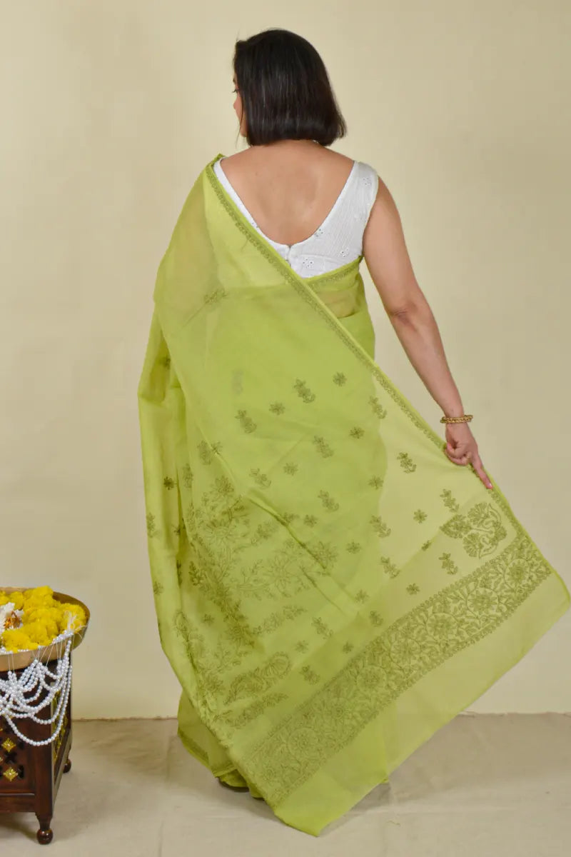 Handcrafted Green Cotton Saree with intricate Lucknowi Chikankari embroidery and a matching blouse, ideal for festive and wedding occasions.
