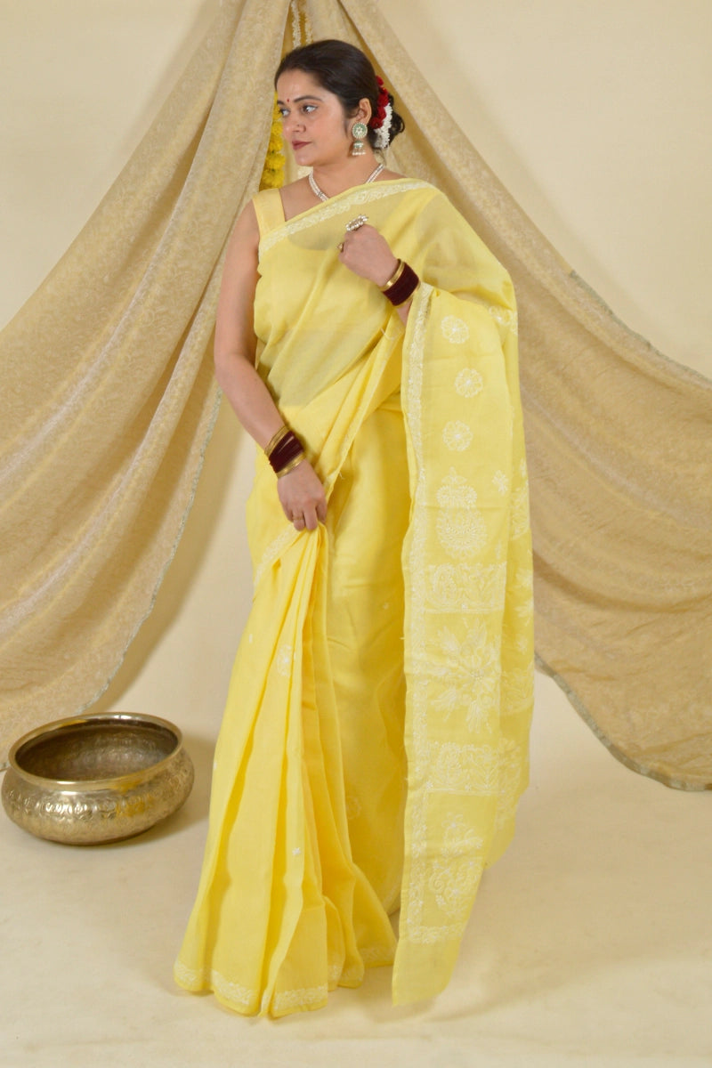 Handcrafted Yellow Saree with intricate Lucknowi Chikankari embroidery and a matching blouse, ideal for festive and wedding occasions.