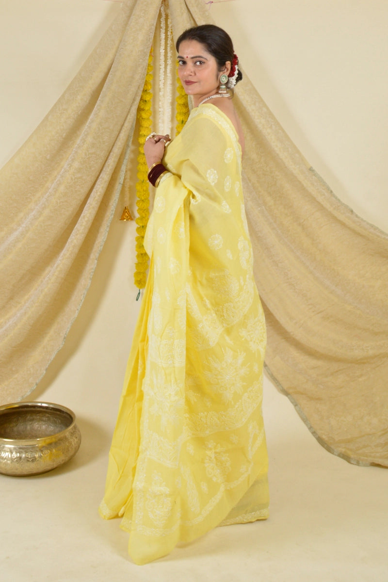 Handcrafted Yellow Saree with intricate Lucknowi Chikankari embroidery and a matching blouse, ideal for festive and wedding occasions.