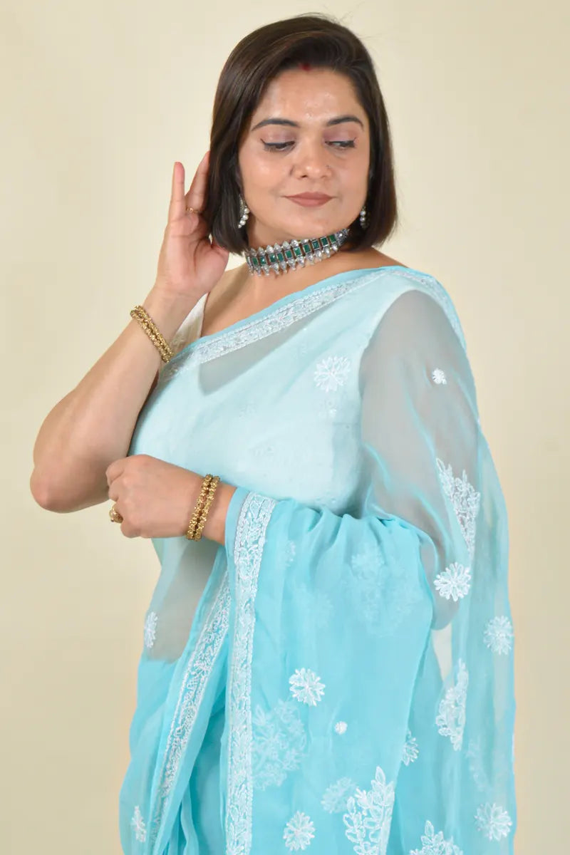 Handcrafted Sky Blue Georgette Saree with intricate Lucknowi Chikankari embroidery and a matching blouse, ideal for Festive and wedding occasions.