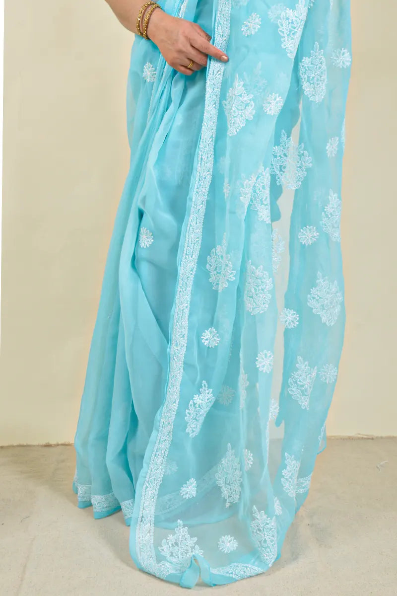 Handcrafted Sky Blue Georgette Saree with intricate Lucknowi Chikankari embroidery and a matching blouse, ideal for Festive and wedding occasions.