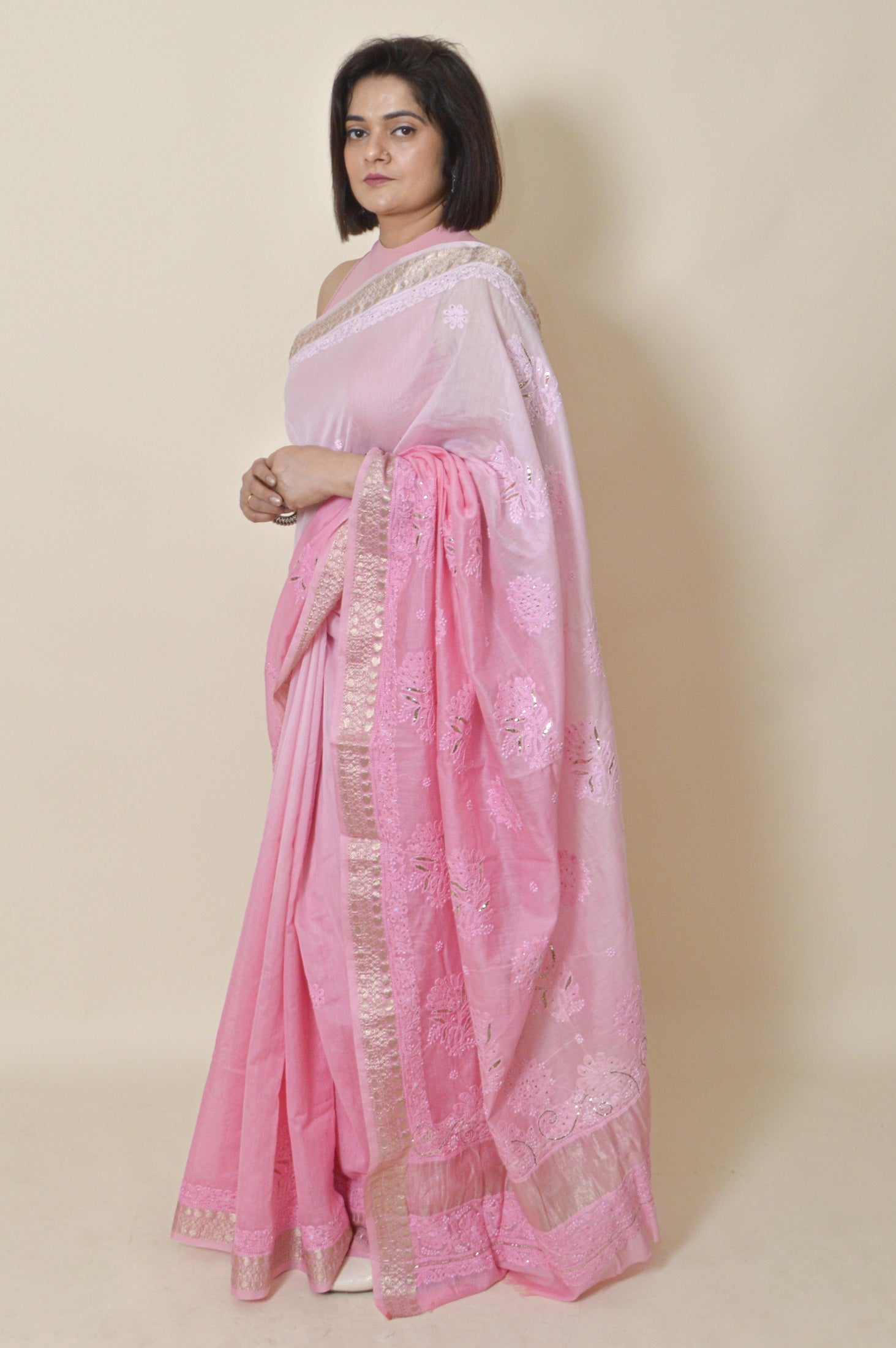 Woman wearing Fabnuma Handcrafted Pink Chanderi Chikankari Saree-Blouse with delicate embroidery and gold border.