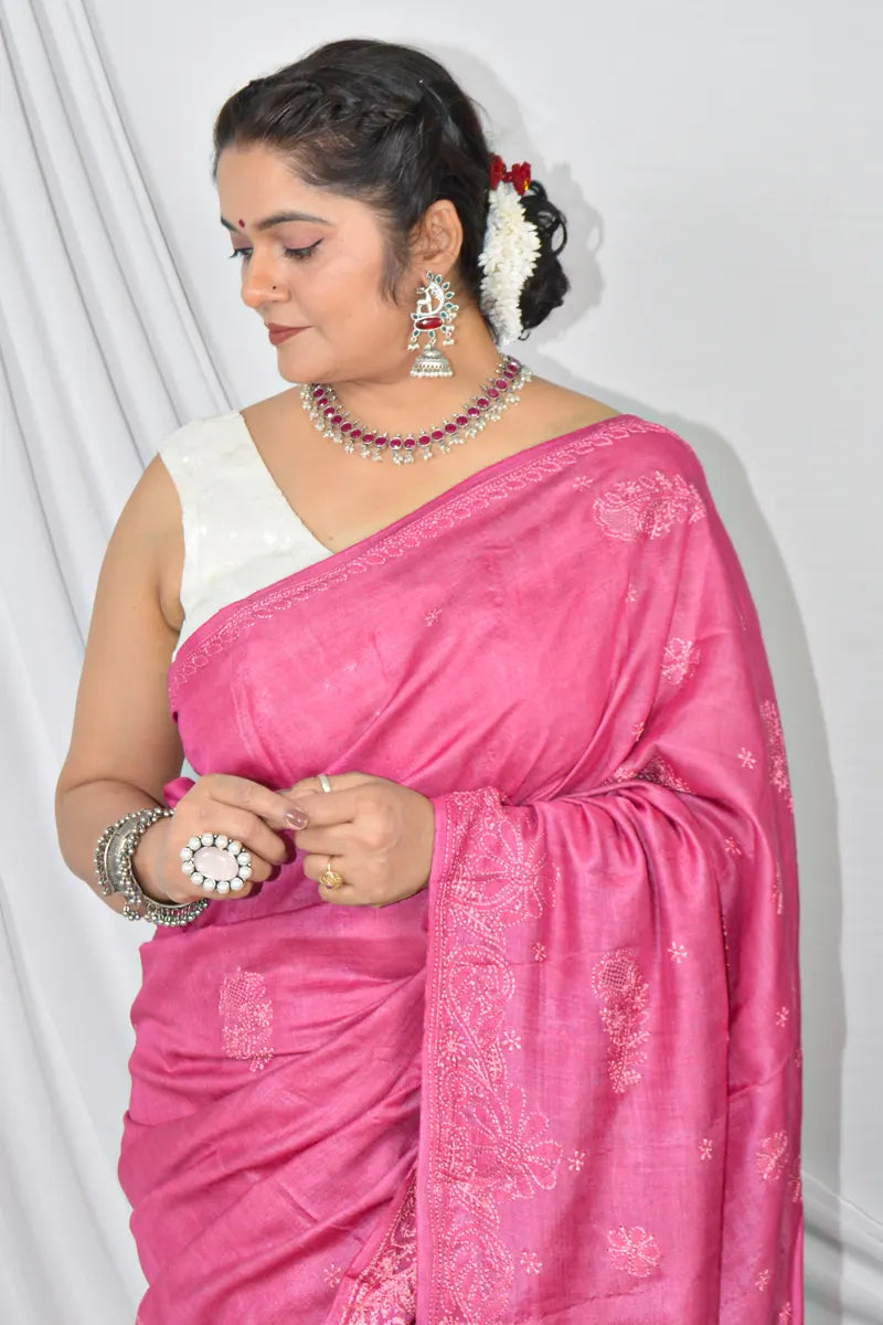 Handcrafted Magenta Pink Tussar silk saree with intricate Lucknowi Chikankari embroidery and a matching blouse, ideal for festive and wedding occasions.