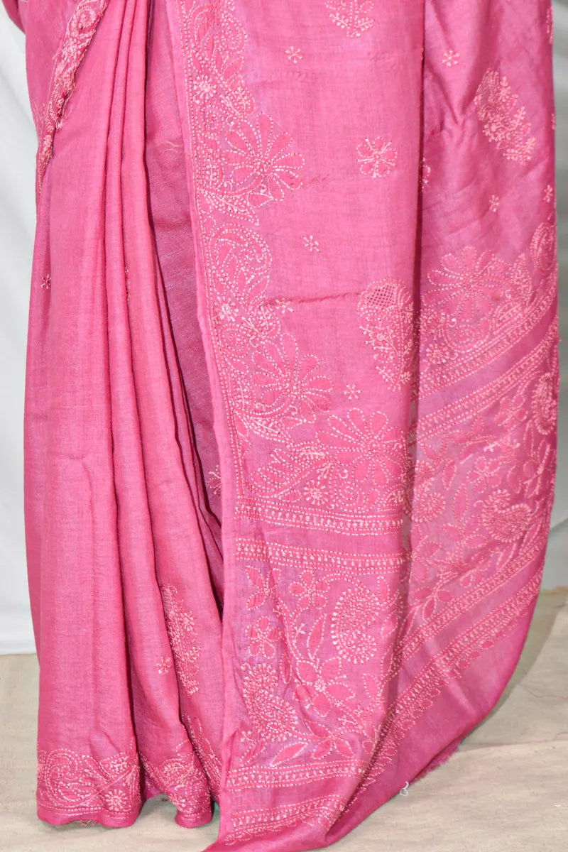 Handcrafted Magenta Pink Tussar silk saree with intricate Lucknowi Chikankari embroidery and a matching blouse, ideal for festive and wedding occasions.