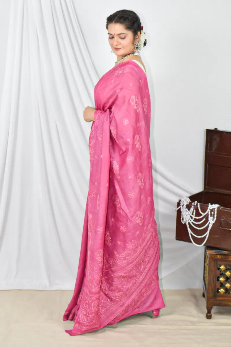 Handcrafted Magenta Pink Tussar silk saree with intricate Lucknowi Chikankari embroidery and a matching blouse, ideal for festive and wedding occasions.