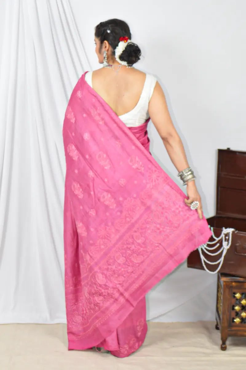 Handcrafted Magenta Pink Tussar silk saree with intricate Lucknowi Chikankari embroidery and a matching blouse, ideal for festive and wedding occasions.
